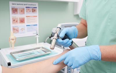 An older male patient receiving a vaccination from a nurse in a clinic setting